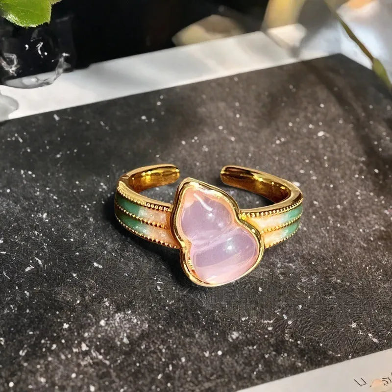 Close-up of a copper adjustable gourd ring with vintage oil-dripping finish and inlaid zircon stone.