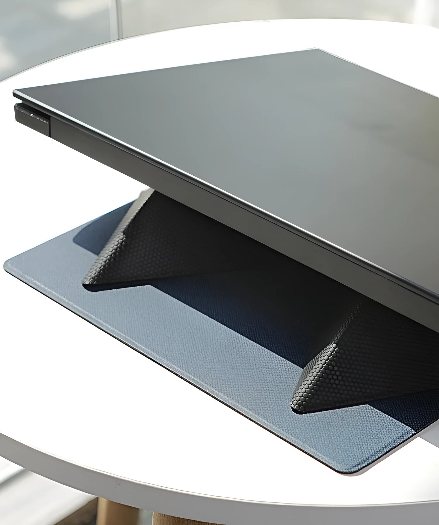 Blue portable laptop cooling bracket showing foldable design with anti-slip surface