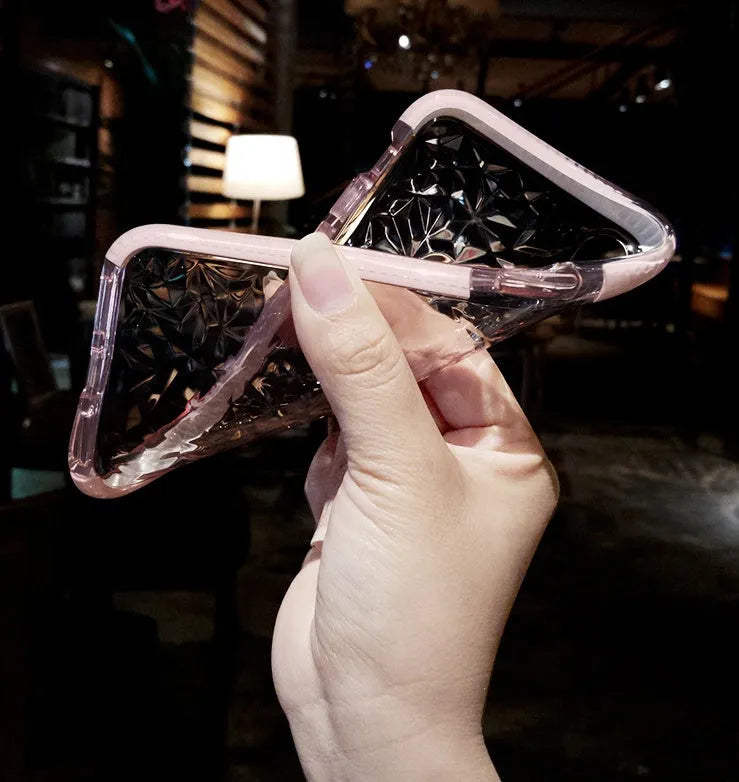Striped TPU iPhone case shown in black, pink, and white edge colour options on a table.