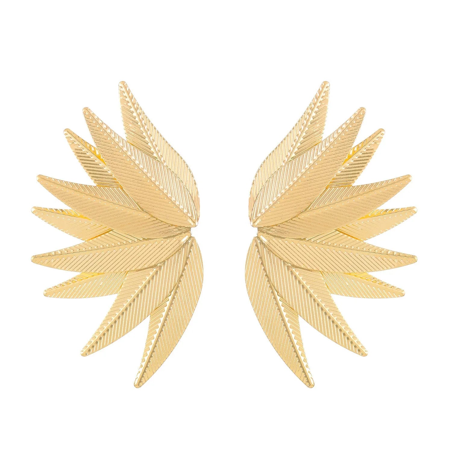 Gold and white alloy leaf shape patch earrings on a flat surface