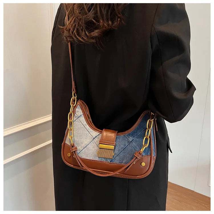Brown denim women's bucket shoulder bag with diamond mesh detail and a chain strap.