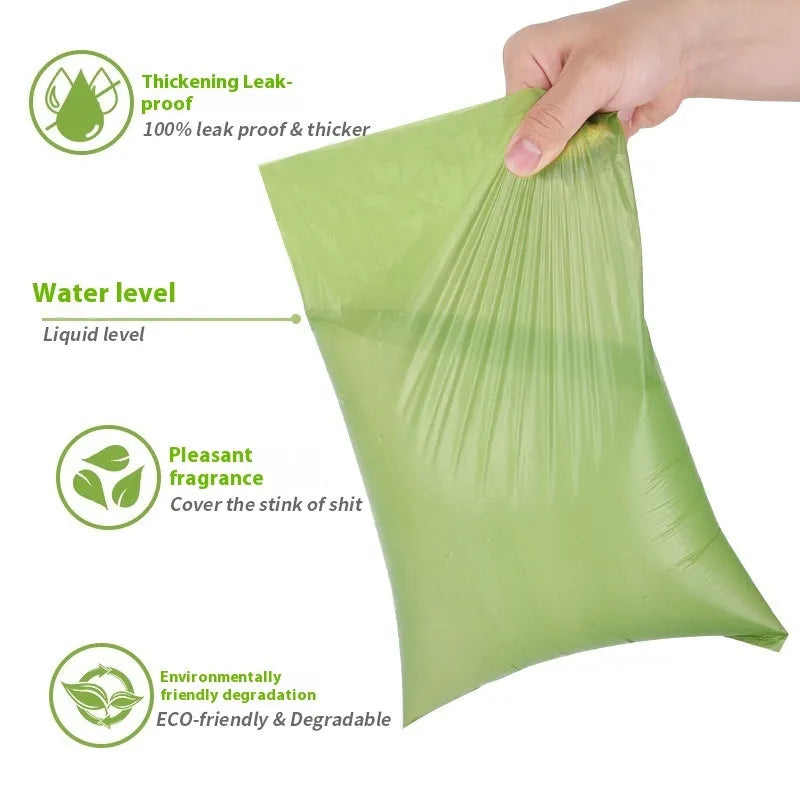 Roll of green EPI degradable pet poop bags next to a transparent dispenser on a dog lead.