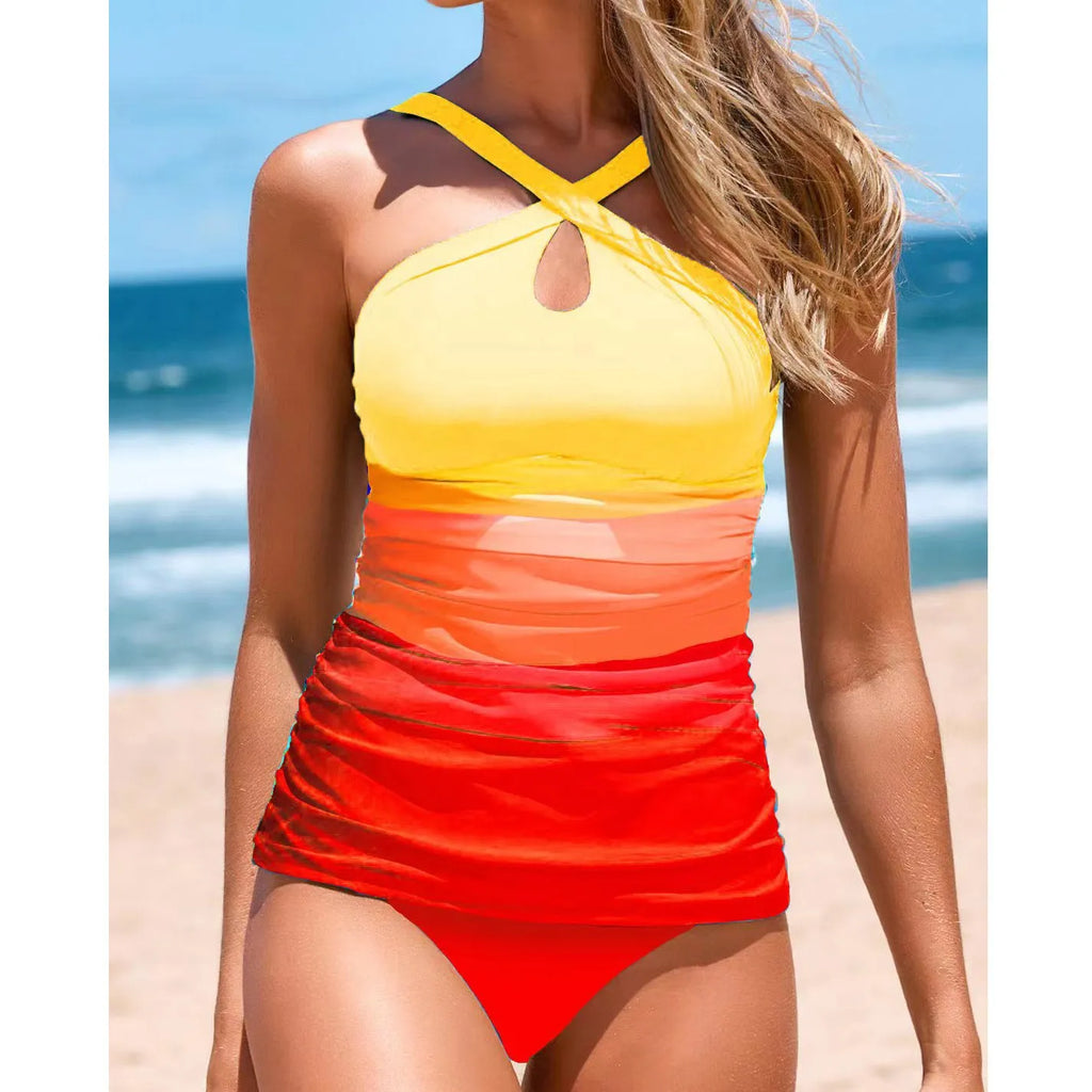 Women's gradient colour cross-strap back swimsuit with heap pleating, shown in a brief style.