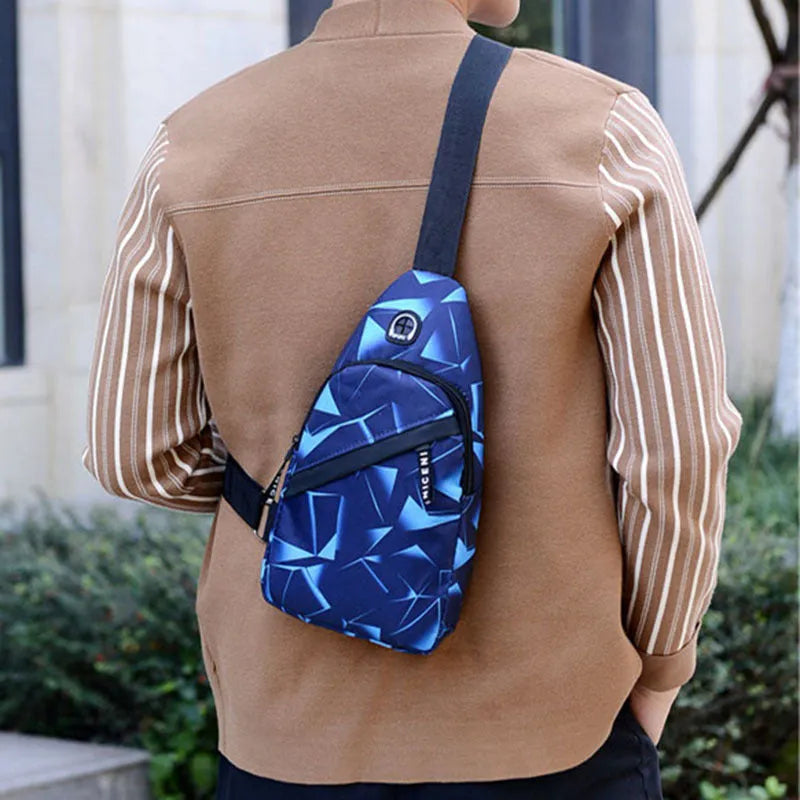 Men's blue print sling chest bag with a visible earphone hole and a single adjustable strap.