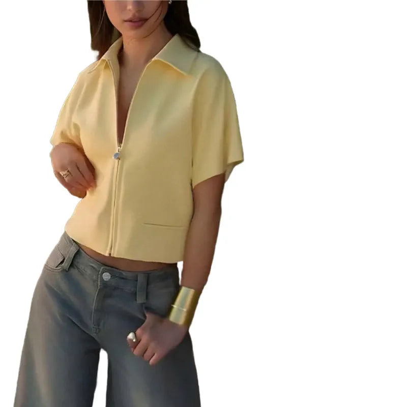 Man wearing a loose-fit yellow casual short-sleeve top on a neutral background.