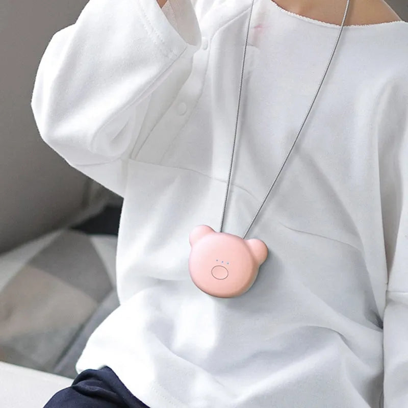 Compact USB-powered air purifier necklace in pink, showing wearable design and one-button control.