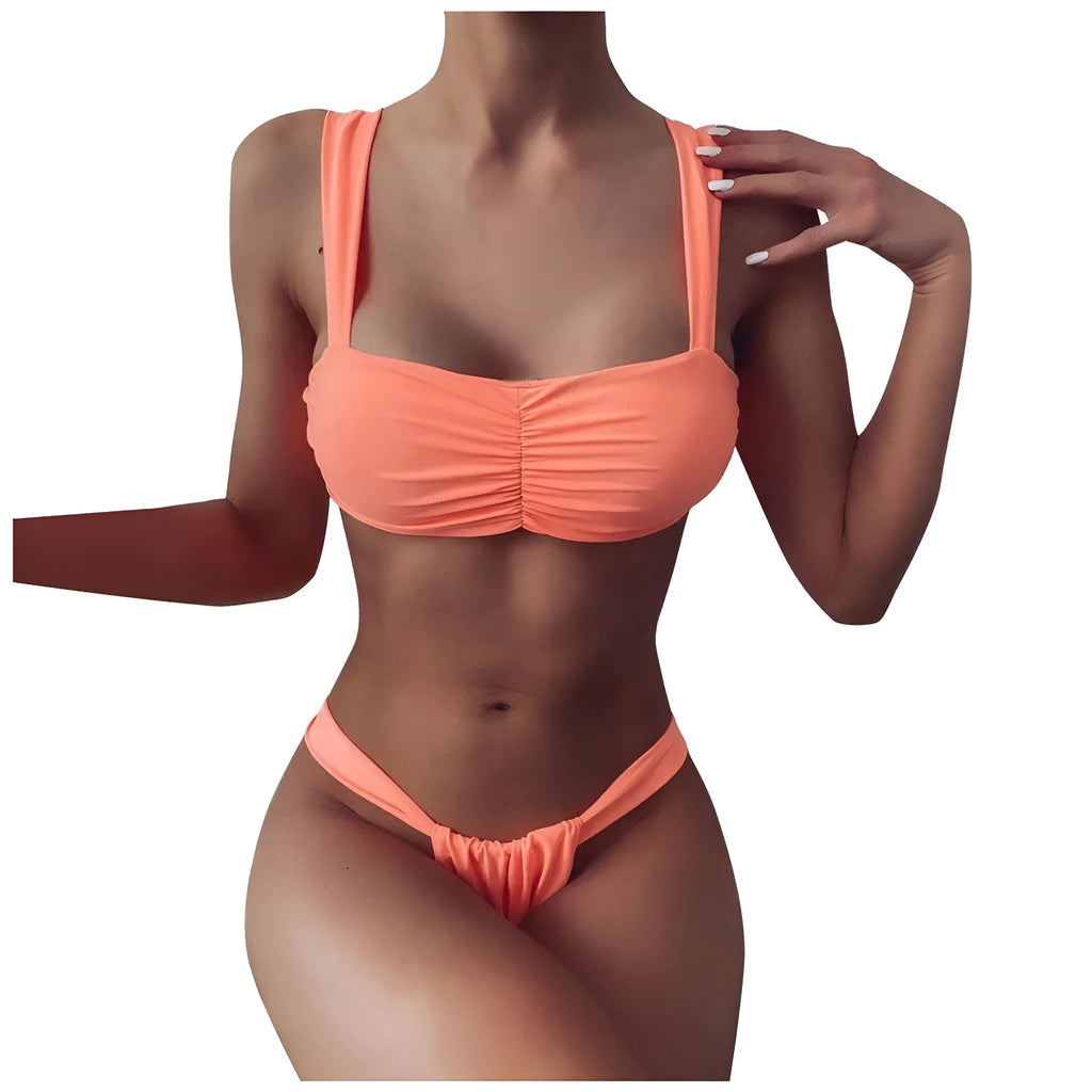 Solid colour orange split bikini swimsuit with high-cut legs on a model by the pool