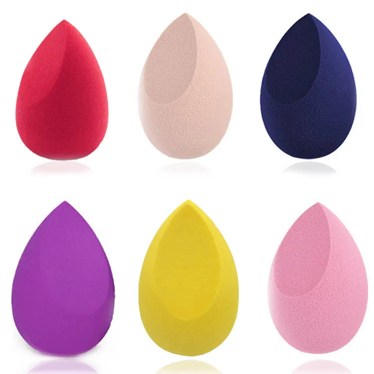 Seven different shaped makeup sponge puffs in various colours including pink, blue and burgundy