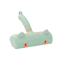Gray self-cleaning two-way pet hair roller brush with non-slip handle on fabric surface