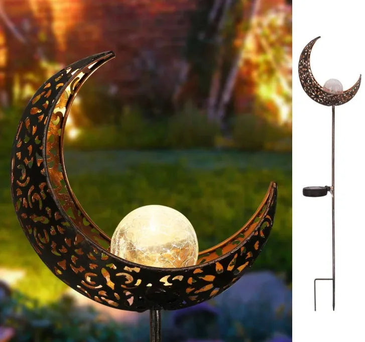 LED solar flame light with warm white glow, iron construction, and glass globe in an outdoor garden setting
