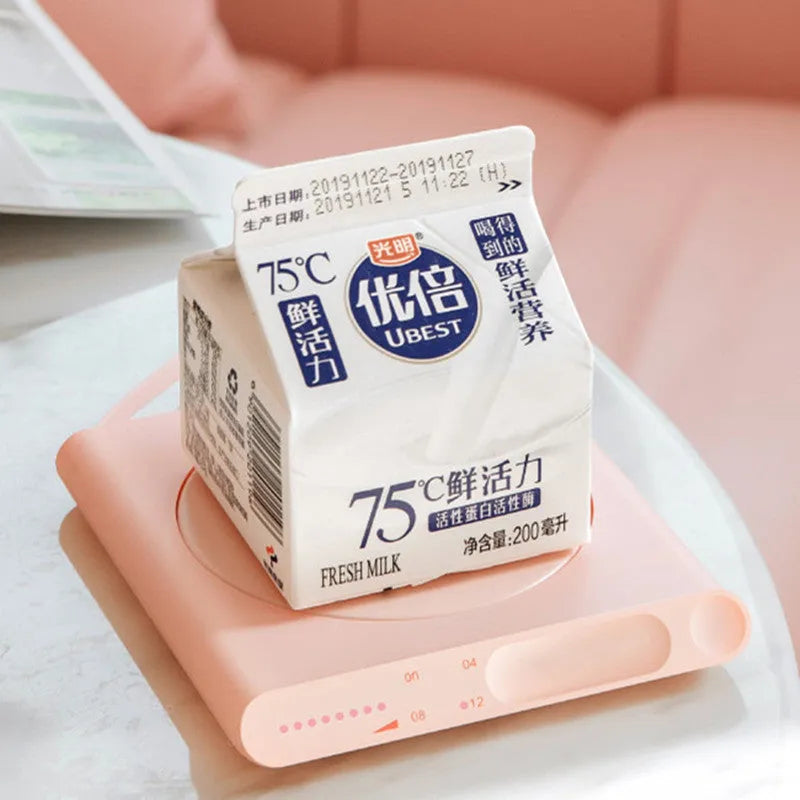 Pink and white USB heating cup pad with mechanical timer for keeping drinks warm