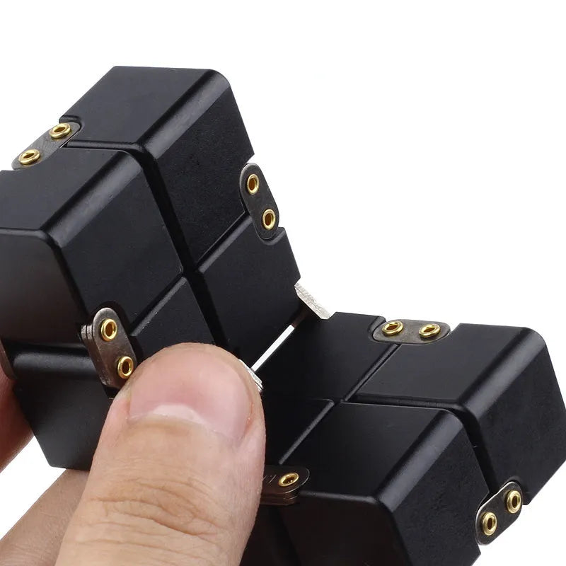 Black zinc alloy infinity cube fidget toy showing rotated cubes, on a white background.