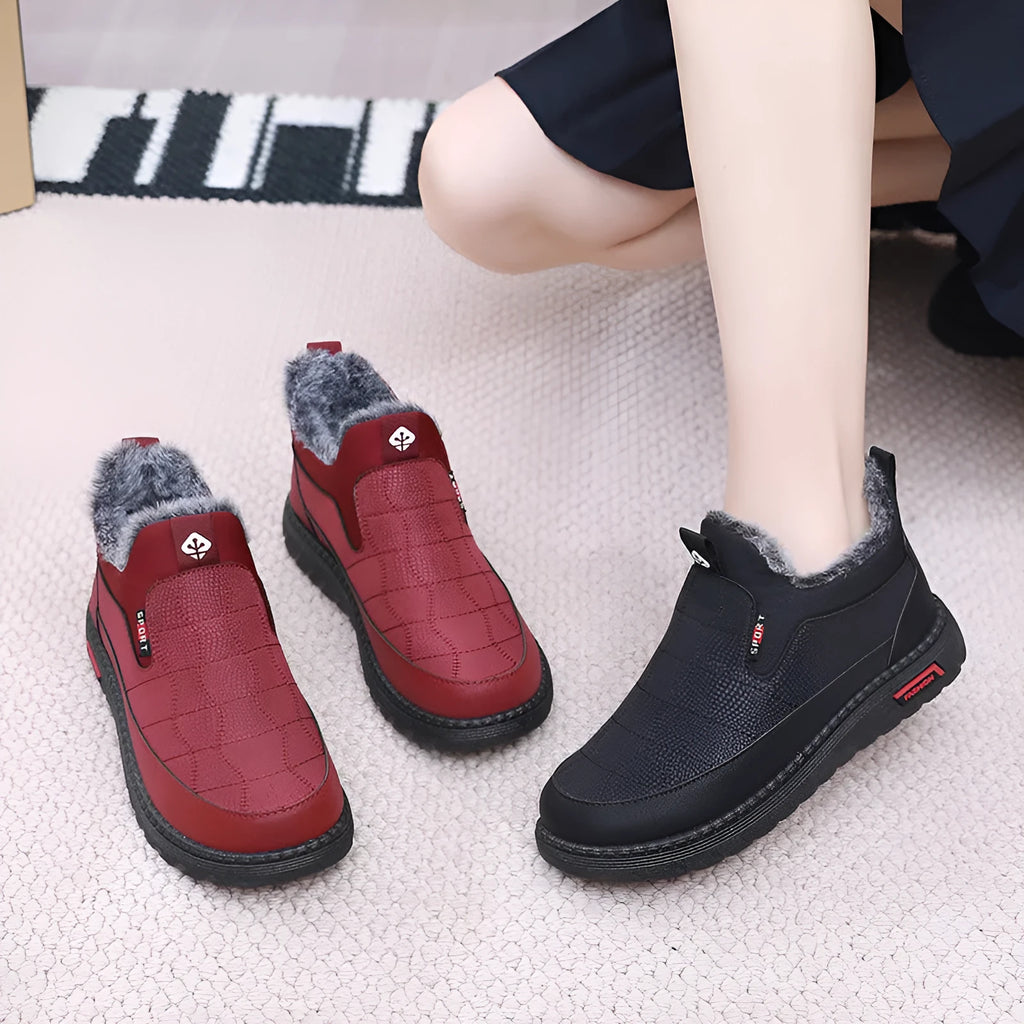 Women's black flat casual ankle boots with round toe and synthetic leather upper
