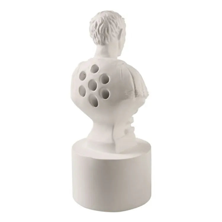 White synthetic resin pen holder with American character sculpture design for holding pens on a desk.