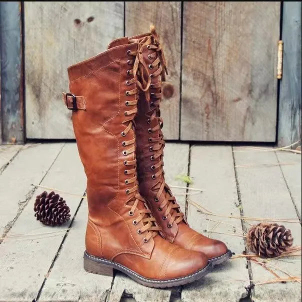 Black chunky heel high leg boots on a white background, showing round toe and stout low heel.