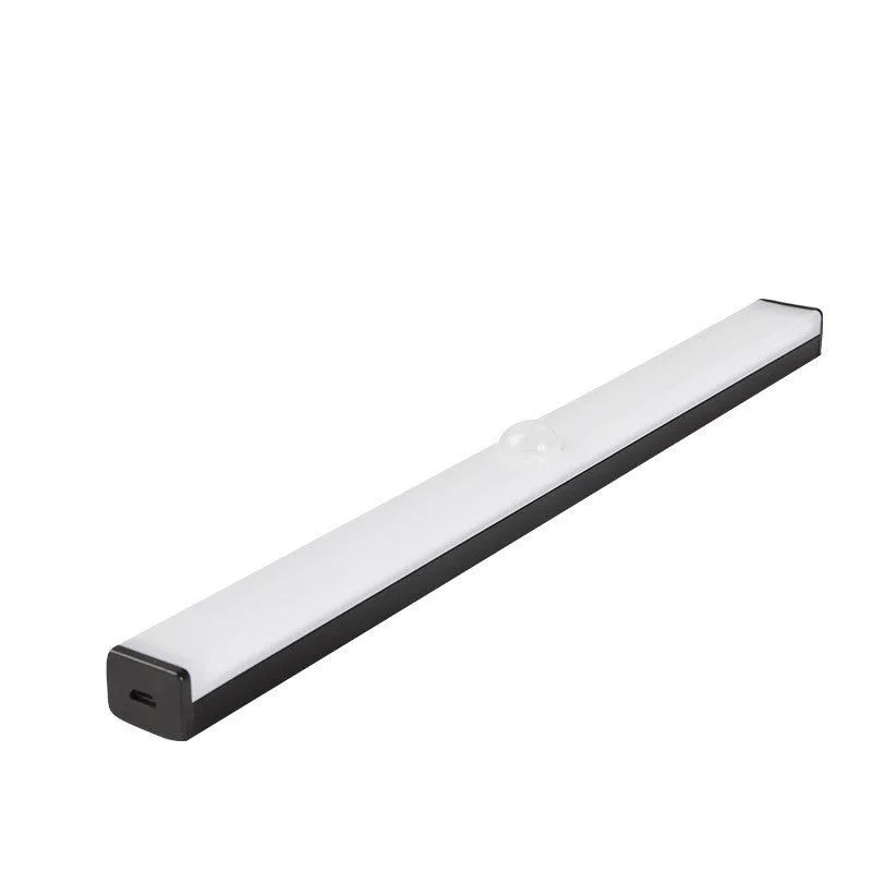 Black battery-powered LED strip light with motion sensor for cabinet or staircase installation.