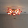A modern white or purple flower-shaped LED ceiling lamp with five or six heads, mounted on a ceiling.