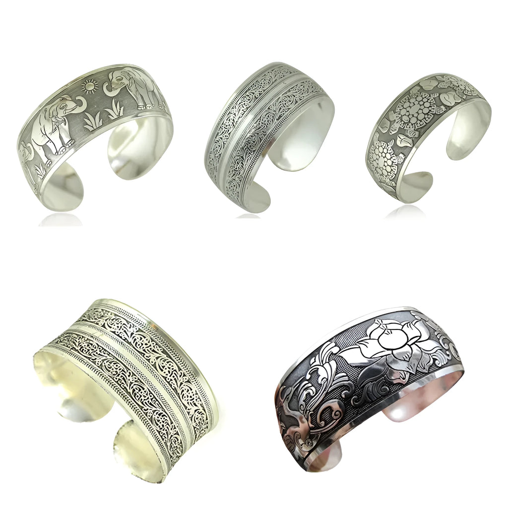 Openwork ethnic bracelet with carved Miao silver finish showing elephant design detail on wrist.