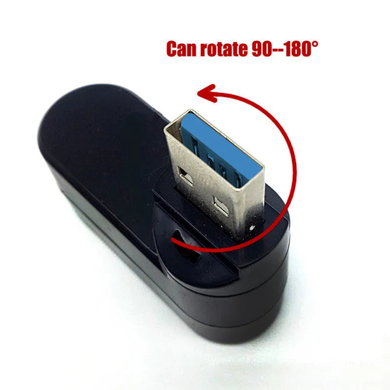 Black USB 3.0 four-port rotary hub on a desk next to a laptop, showing compact size.
