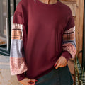 Women's loose fit apricot plaid stitch long sleeve pullover top on hanger.