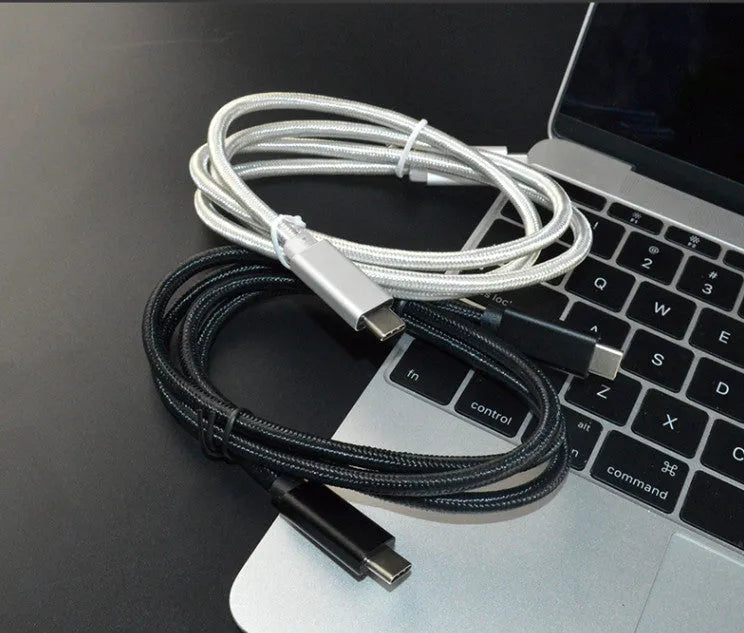 Black USB-C to USB-C cable with stainless steel plug, shown coiled, for 100W charging and 4K video.