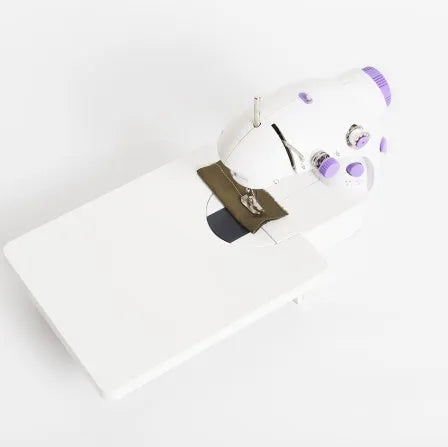 Electric mini household sewing machine showing compact 20cm size with power supply and accessories