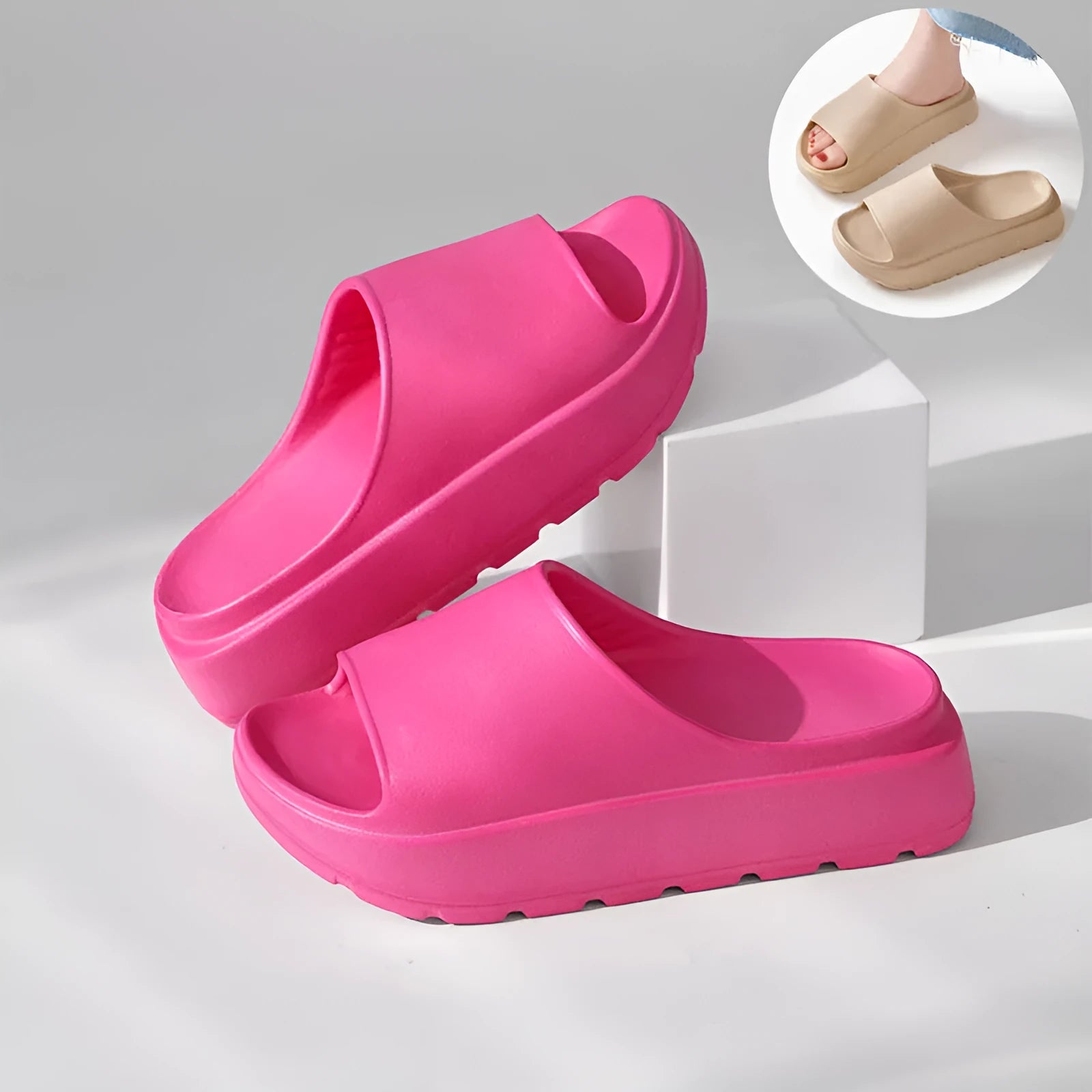 Women's beige fish mouth slippers with a thick light-coloured sole on a wooden floor.