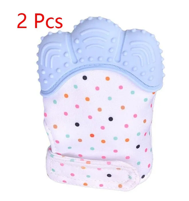 BPA-free silicone baby teether glove fastened with a white Velcro strap on a baby's hand