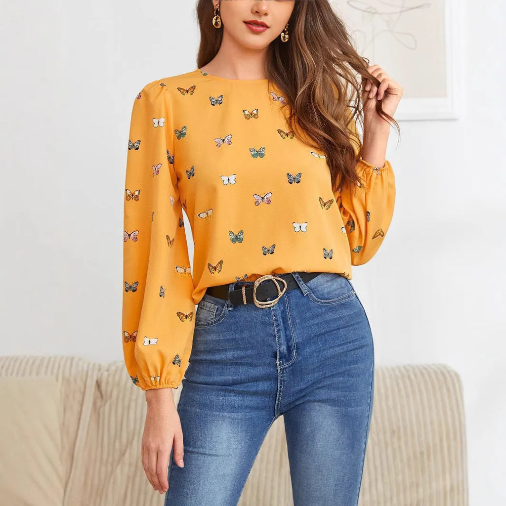 Green women's long-sleeved shirt with butterfly print, showing loose fit and long sleeves.