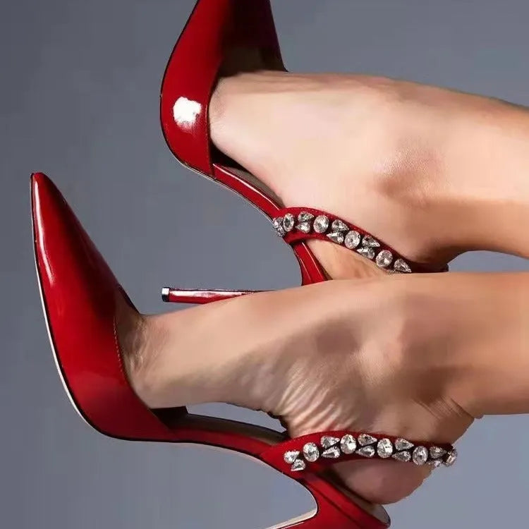 Women's black patent leather pointed toe high heel sandals with rhinestone decoration on the side.