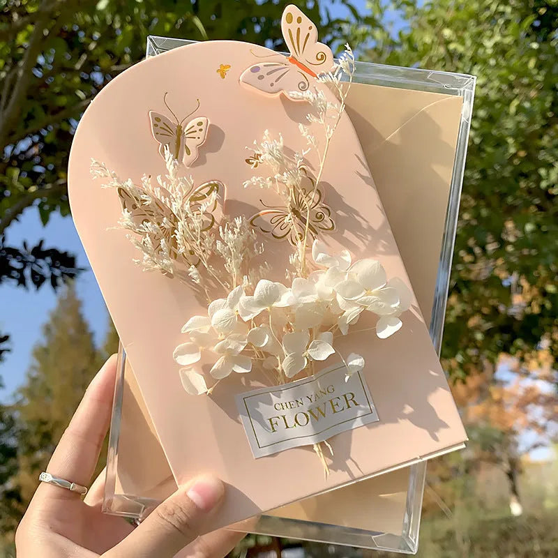Handmade 3D butterfly birthday greeting card with artificial flowers, shown with its envelope.
