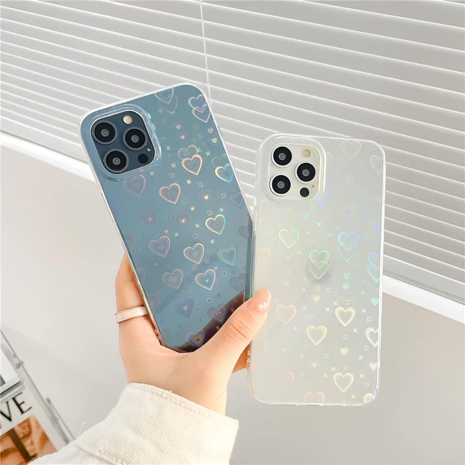 Transparent silicone iPhone case with a laser-etched colourful love design, shown next to a butterfly-accented variant.