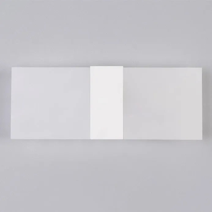 Black acrylic LED wall lamp mounted on a wall, measuring 27cm by 10cm.