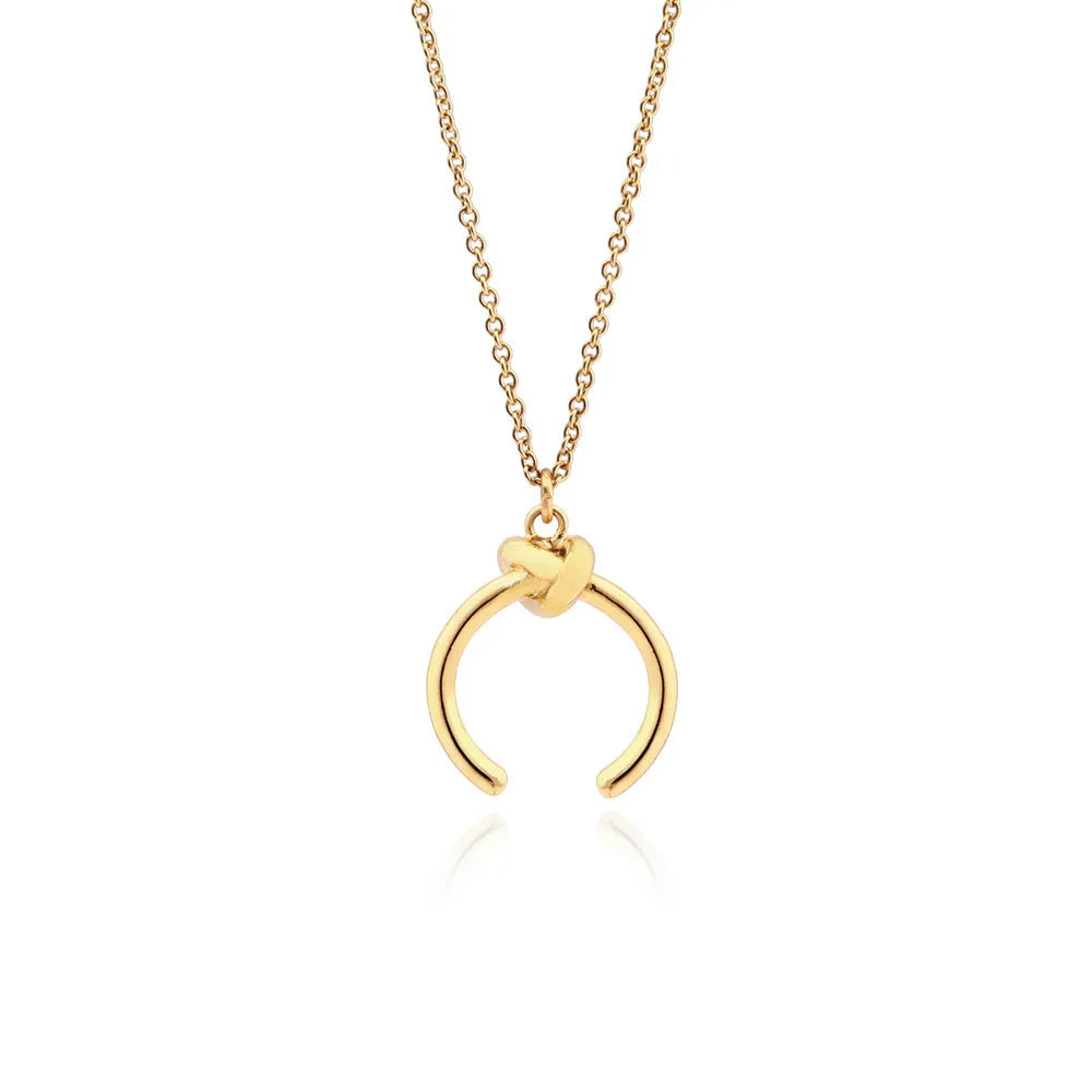 Gold geometric pendant necklace on a cross chain, shown at an adjustable length.