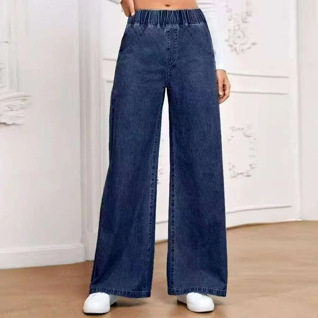 Light blue washed plus size women's wide-leg denim jeans with straight cut and zip fly