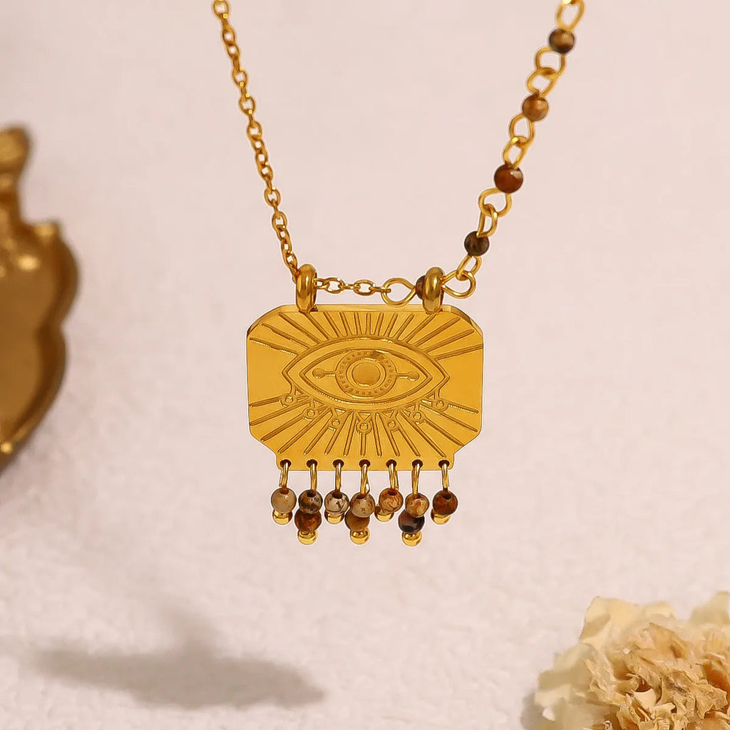 Retro gold titanium steel chain necklace with square natural stone pendant and evil eye motif on white background