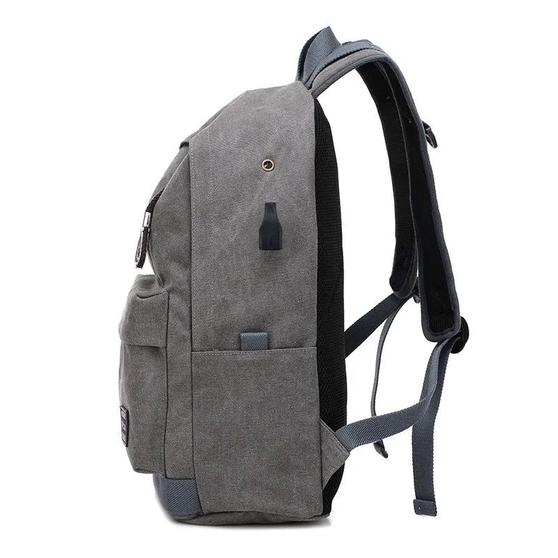 Canvas backpack with USB charging port shown in grey colour, featuring multiple pockets and straps.