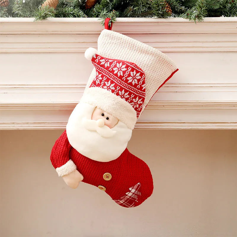 Large red and white knitted Christmas stocking with Santa Claus or Snowman design on a fireplace mantel