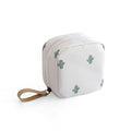 Cloth cube-shaped makeup storage bag in a plain colour on a neutral background.