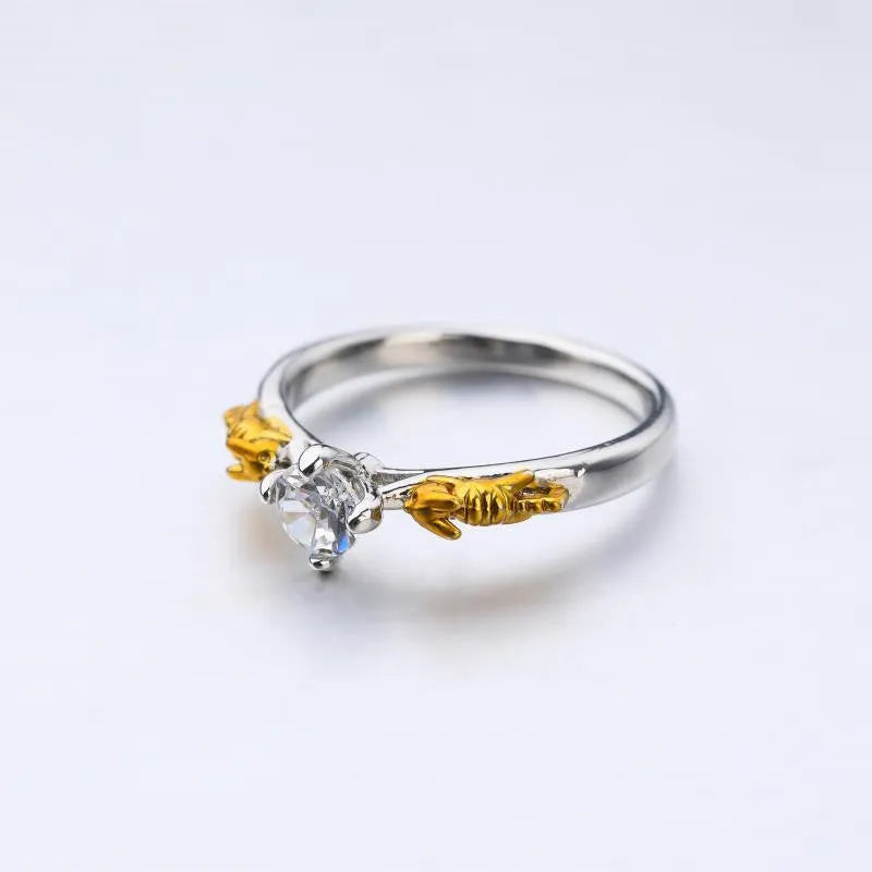 A black gold finished crown motif ring on a copper base, shown on a finger, with detailed modelling visible.