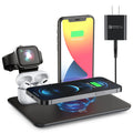 Black desktop charging hub showing wireless phone pad, USB port, watch port, and headphone charging dock.
