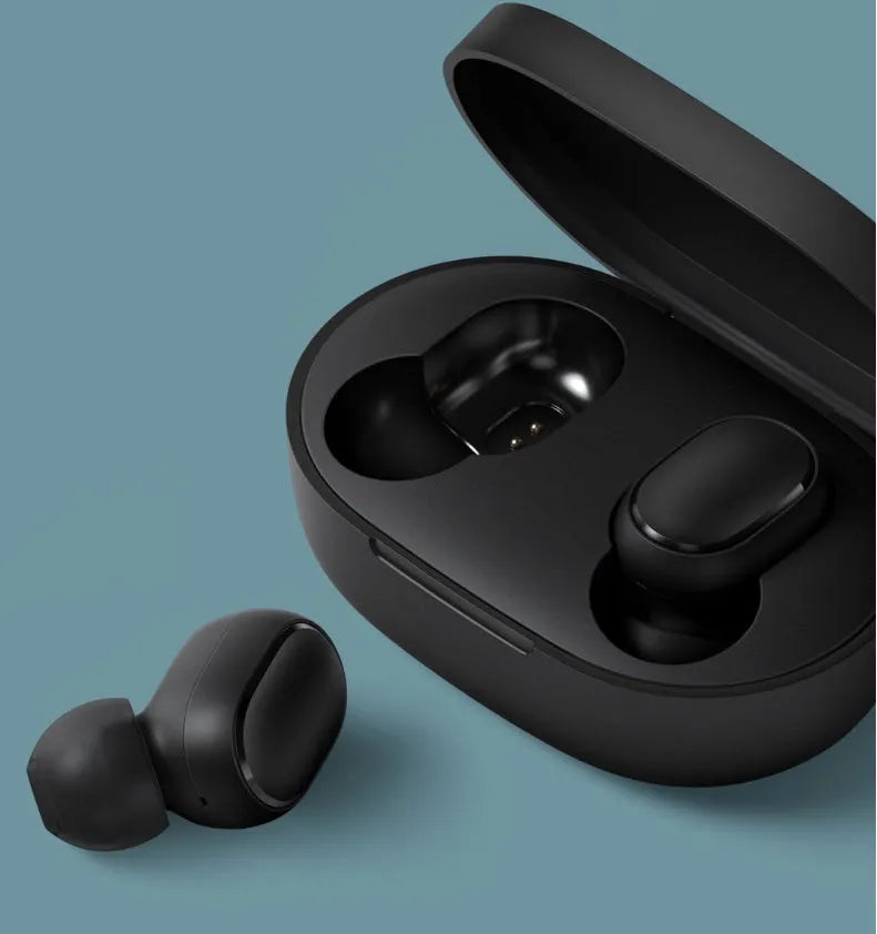 Black Redmi AirDots true wireless earbuds next to their compact charging case.