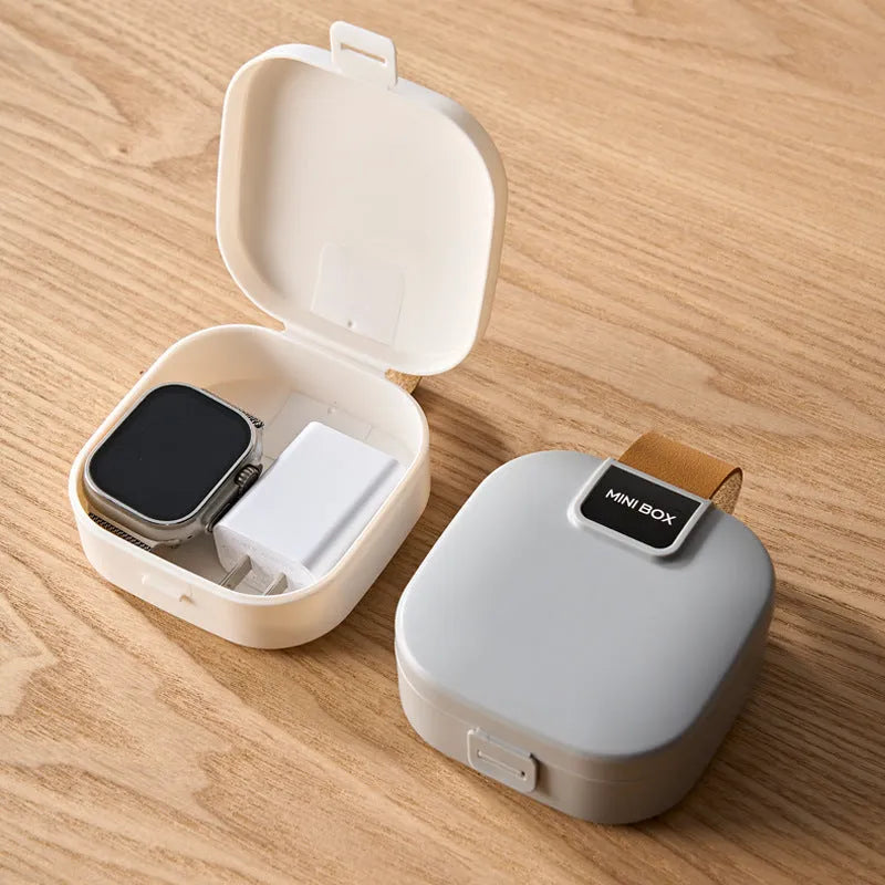 Solid colour plastic Bluetooth headset storage box with lid, 9cm by 4.5cm, in light gray.