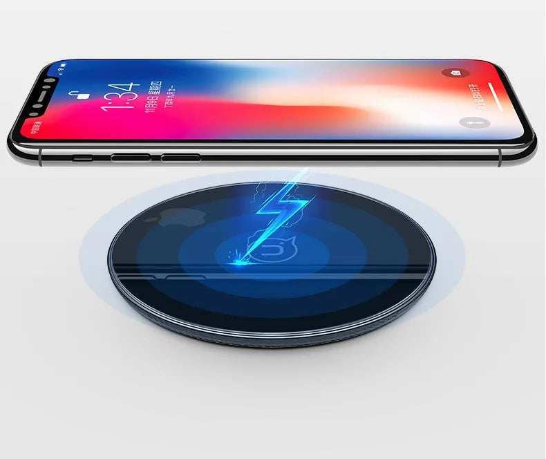 Black glass disc wireless charger with LED indicator light on smooth surface