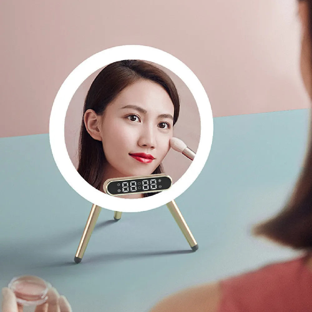 White multi-function LED mirror alarm clock with wireless charger and Bluetooth speaker on a table