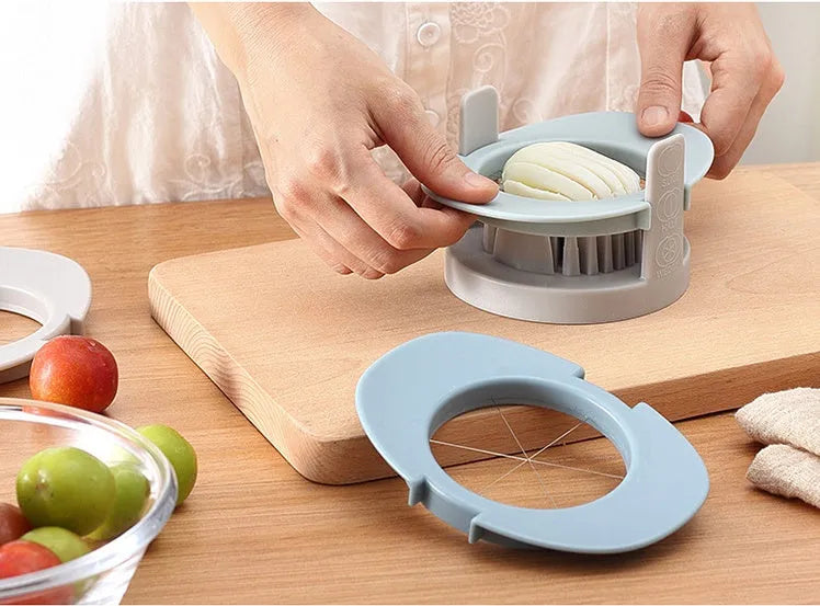 Manual three-in-one egg cutter in blue, orange and red with stainless steel blades and stackable design