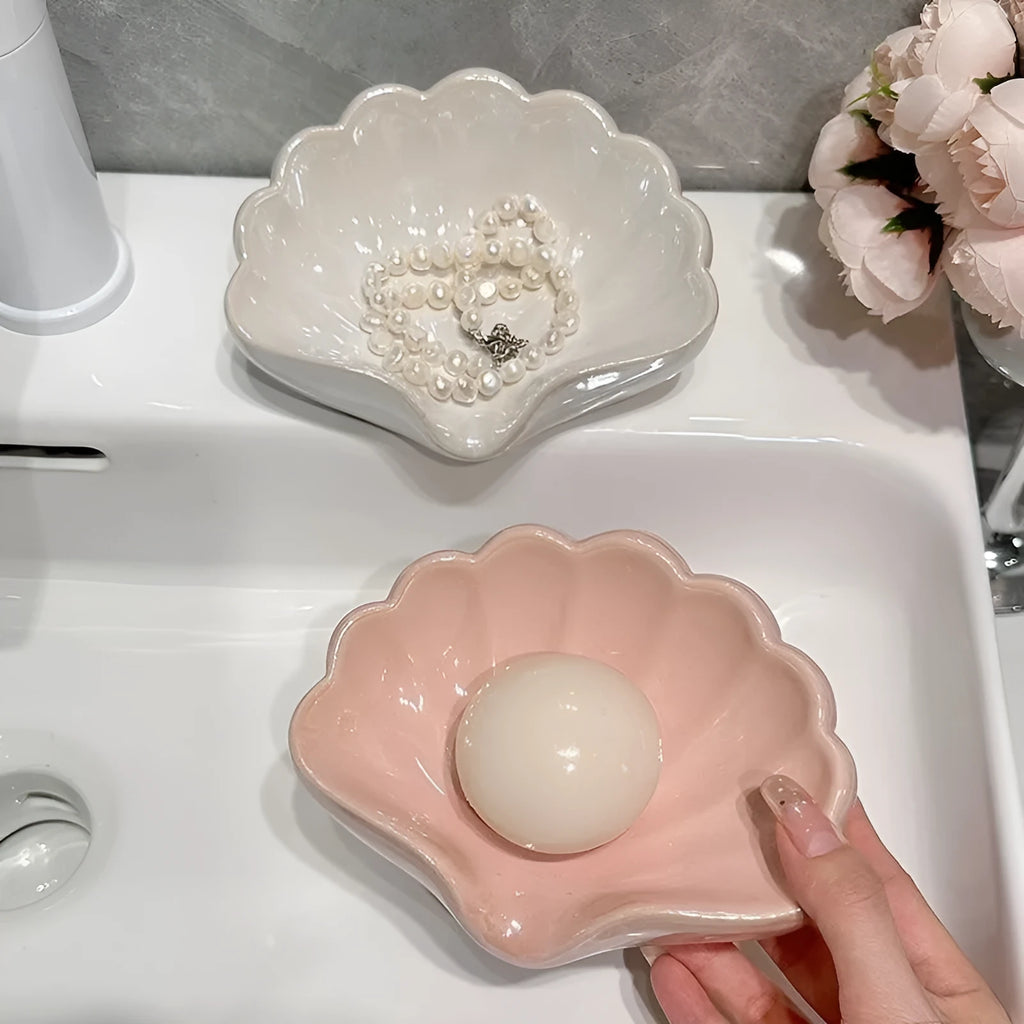 White plastic shell-shaped soap dish for bathroom countertop