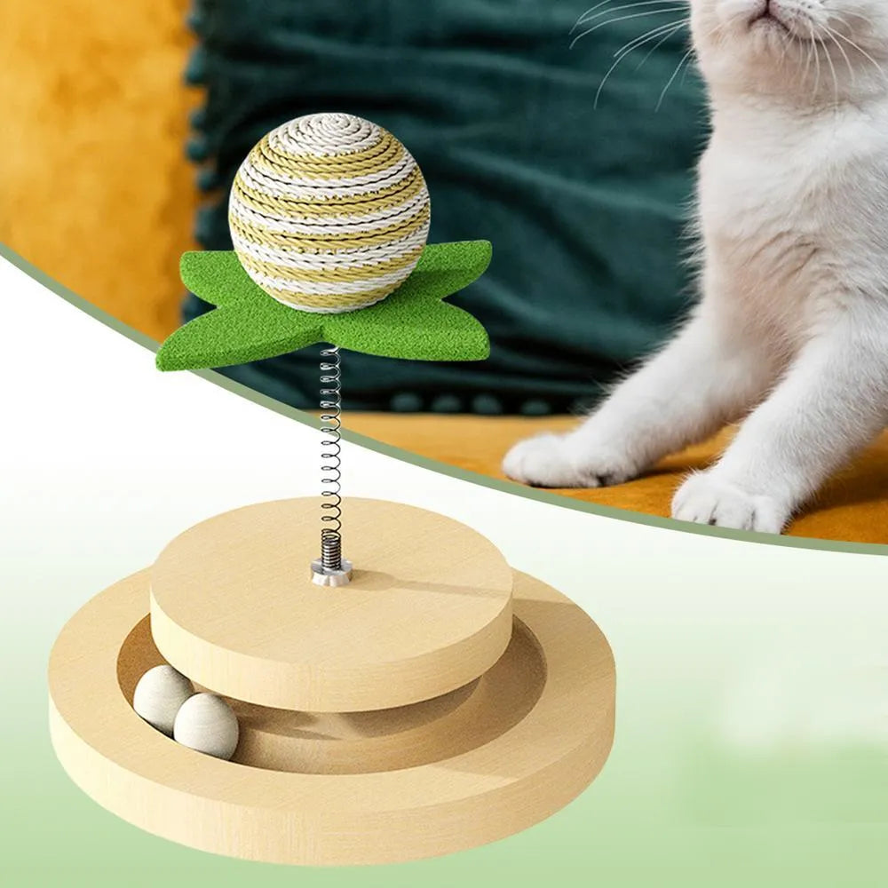 Green cat toy with a sisal scratching centre and a circular plastic ball track on a turntable.