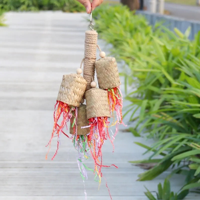 Shredded paper bird toy with colourful paper strips on wooden frame with sisal rope, measuring 15 by 35cm
