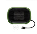 Compact green mini ceramic heater on a desktop showing its small size and EU plug.